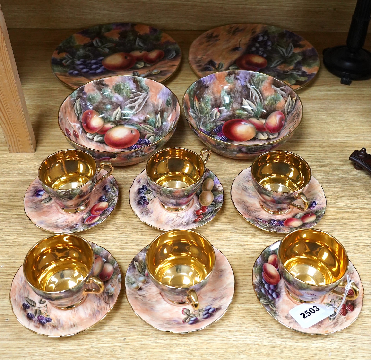 A tea set painted with still life of fruit, Studio D.R.B., comprising six cups and saucers, two bowls and two plates